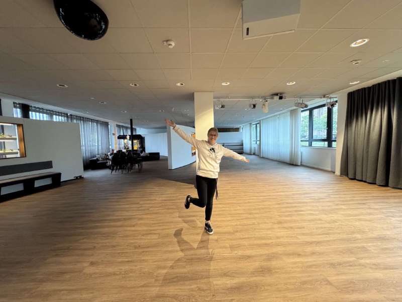 A colleague celebrating in the cleared-out festival space in our office